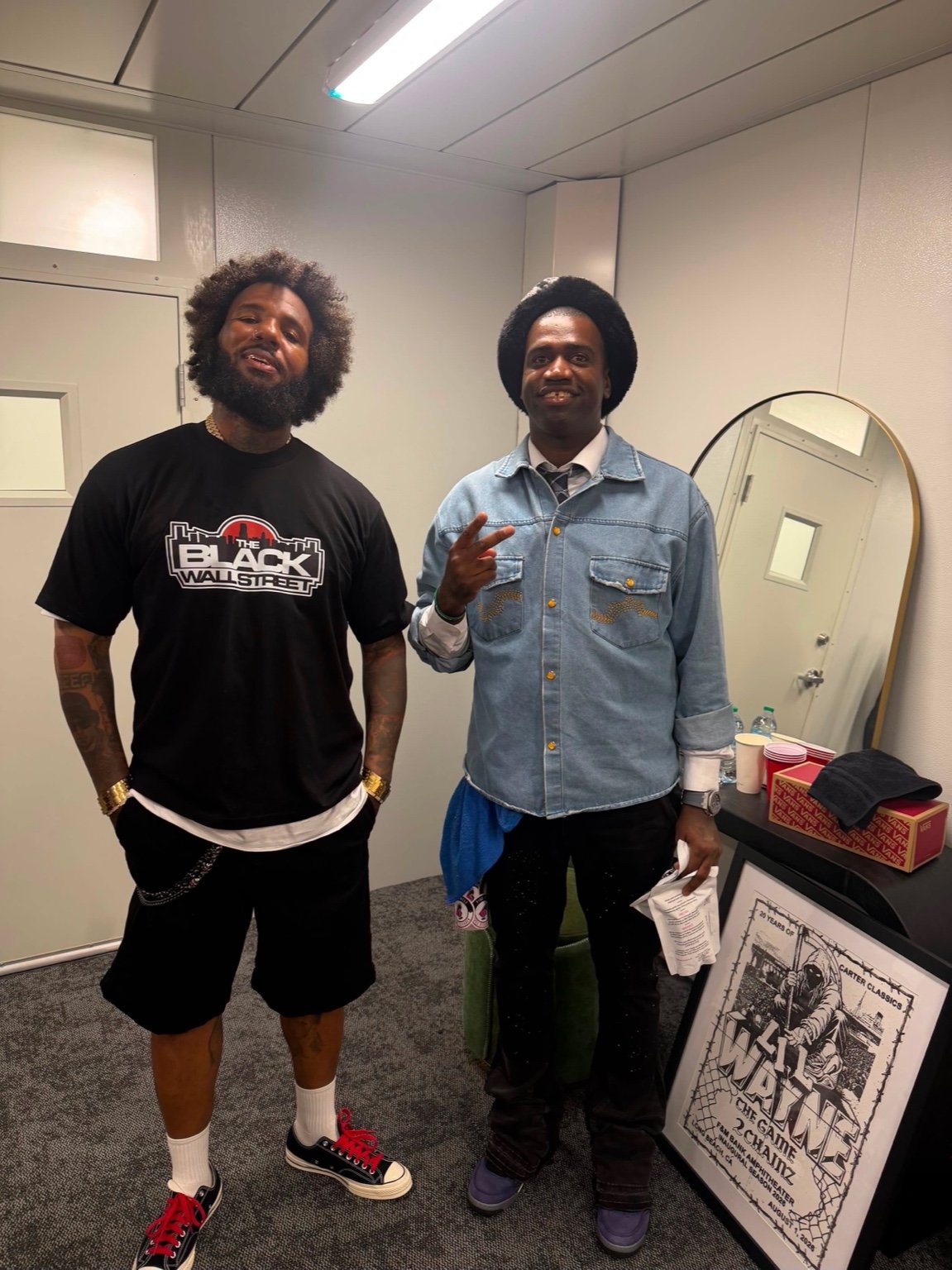 Two men standing together, with one wearing the black BWS Logo Tee